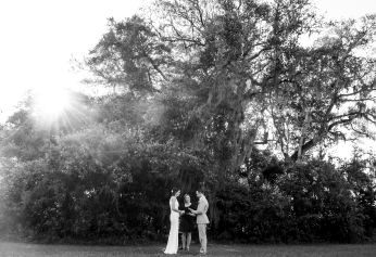 Officiant and couple under live oak with Spanish moss